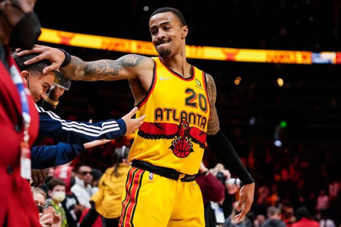 Atlanta Hawks forward John Collins (20) reacts with Trae Young s brother Tim after the Hawks defeated the Los Angeles Lakers at State Farm Arena.